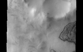 <h1>PIA09279:  Frosty Dunes</h1><div class="PIA09279" lang="en" style="width:449px;text-align:left;margin:auto;background-color:#000;padding:10px;max-height:150px;overflow:auto;"><p><a href="/figures/PIA09279_fig1.jpg"></a><br><b>Context image for PIA09279<br />Frosty Dunes</b></p><p>This image shows part of Phillips Crater and a small crater on its rim. Dark dunes occur within both craters, seen here with their winter frost covers beginning to disappear.<p>Image information: VIS instrument. Latitude -65.5N, Longitude 312.1E. 17 meter/pixel resolution.</p><p>Please see the <a href="http://themis.asu.edu/terms" target="_blank">THEMIS Data Citation Note</a> for details on crediting THEMIS images.</p><p>Note: this THEMIS visual image has not been radiometrically nor geometrically calibrated for this preliminary release. An empirical correction has been performed to remove instrumental effects. A linear shift has been applied in the cross-track and down-track direction to approximate spacecraft and planetary motion. Fully calibrated and geometrically projected images will be released through the Planetary Data System in accordance with Project policies at a later time.</p><p>NASA's Jet Propulsion Laboratory manages the 2001 Mars Odyssey mission for NASA's Office of Space Science, Washington, D.C. The Thermal Emission Imaging System (THEMIS) was developed by Arizona State University, Tempe, in collaboration with Raytheon Santa Barbara Remote Sensing. The THEMIS investigation is led by Dr. Philip Christensen at Arizona State University. Lockheed Martin Astronautics, Denver, is the prime contractor for the Odyssey project, and developed and built the orbiter. Mission operations are conducted jointly from Lockheed Martin and from JPL, a division of the California Institute of Technology in Pasadena.</p><br /><br /><a href="http://photojournal.jpl.nasa.gov/catalog/PIA09279" onclick="window.open(this.href); return false;" title="Voir l'image 	 PIA09279:  Frosty Dunes	  sur le site de la NASA">Voir l'image 	 PIA09279:  Frosty Dunes	  sur le site de la NASA.</a></div>