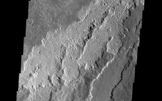 <h1>PIA09296:  Arsia Mons Flows</h1><div class="PIA09296" lang="en" style="width:548px;text-align:left;margin:auto;background-color:#000;padding:10px;max-height:150px;overflow:auto;"><p><a href="/figures/PIA09296_fig1.jpg"></a><br><b>Context image for PIA09296<br />Arsia Mons Flows</b></p><p>The rough and smooth lava flows in this image are part of the extensive flows from Arsia Mons.<p>Image information: VIS instrument. Latitude -20.9N, Longitude 235.2E. 17 meter/pixel resolution.</p><p>Please see the <a href="http://themis.asu.edu/terms" target="_blank">THEMIS Data Citation Note</a> for details on crediting THEMIS images.</p><p>Note: this THEMIS visual image has not been radiometrically nor geometrically calibrated for this preliminary release. An empirical correction has been performed to remove instrumental effects. A linear shift has been applied in the cross-track and down-track direction to approximate spacecraft and planetary motion. Fully calibrated and geometrically projected images will be released through the Planetary Data System in accordance with Project policies at a later time.</p><p>NASA's Jet Propulsion Laboratory manages the 2001 Mars Odyssey mission for NASA's Office of Space Science, Washington, D.C. The Thermal Emission Imaging System (THEMIS) was developed by Arizona State University, Tempe, in collaboration with Raytheon Santa Barbara Remote Sensing. The THEMIS investigation is led by Dr. Philip Christensen at Arizona State University. Lockheed Martin Astronautics, Denver, is the prime contractor for the Odyssey project, and developed and built the orbiter. Mission operations are conducted jointly from Lockheed Martin and from JPL, a division of the California Institute of Technology in Pasadena.</p><br /><br /><a href="http://photojournal.jpl.nasa.gov/catalog/PIA09296" onclick="window.open(this.href); return false;" title="Voir l'image 	 PIA09296:  Arsia Mons Flows	  sur le site de la NASA">Voir l'image 	 PIA09296:  Arsia Mons Flows	  sur le site de la NASA.</a></div>