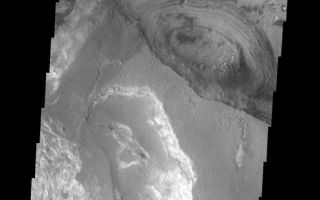 <h1>PIA09309:  Candor Chasma Floor</h1><div class="PIA09309" lang="en" style="width:558px;text-align:left;margin:auto;background-color:#000;padding:10px;max-height:150px;overflow:auto;"><p><a href="/figures/PIA09309_fig1.jpg"></a><br><b>Context image for PIA09309<br />Candor Chasma Floor</b></p><p>This VIS image shows a small portion of the floor of Candor Chasma, part of Vallis Marineris. Different layers and textures are seen in this image.<p>Image information: VIS instrument. Latitude -6.6N, Longitude 284.9E. 18 meter/pixel resolution.</p><p>Please see the <a href="http://themis.asu.edu/terms" target="_blank">THEMIS Data Citation Note</a> for details on crediting THEMIS images.</p><p>Note: this THEMIS visual image has not been radiometrically nor geometrically calibrated for this preliminary release. An empirical correction has been performed to remove instrumental effects. A linear shift has been applied in the cross-track and down-track direction to approximate spacecraft and planetary motion. Fully calibrated and geometrically projected images will be released through the Planetary Data System in accordance with Project policies at a later time.</p><p>NASA's Jet Propulsion Laboratory manages the 2001 Mars Odyssey mission for NASA's Office of Space Science, Washington, D.C. The Thermal Emission Imaging System (THEMIS) was developed by Arizona State University, Tempe, in collaboration with Raytheon Santa Barbara Remote Sensing. The THEMIS investigation is led by Dr. Philip Christensen at Arizona State University. Lockheed Martin Astronautics, Denver, is the prime contractor for the Odyssey project, and developed and built the orbiter. Mission operations are conducted jointly from Lockheed Martin and from JPL, a division of the California Institute of Technology in Pasadena.</p><br /><br /><a href="http://photojournal.jpl.nasa.gov/catalog/PIA09309" onclick="window.open(this.href); return false;" title="Voir l'image 	 PIA09309:  Candor Chasma Floor	  sur le site de la NASA">Voir l'image 	 PIA09309:  Candor Chasma Floor	  sur le site de la NASA.</a></div>