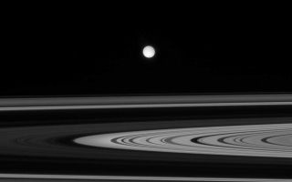 <h1>PIA09786:  Enceladus Afar</h1><div class="PIA09786" lang="en" style="width:800px;text-align:left;margin:auto;background-color:#000;padding:10px;max-height:150px;overflow:auto;"><p>Enceladus is seen here, across the unilluminated side of Saturn's rings. A hint of the moon's active south polar region can be seen as a just slightly dark area at bottom.</p><p>This view was obtained from about 1 degree above the ringplane. Enceladus is 505 kilometers (314 miles) across.</p><p>The image was taken in polarized green light with the Cassini spacecraft narrow-angle camera on Oct. 27, 2007. The view was acquired at a distance of approximately 2.1 million kilometers (1.3 million miles) from Enceladus. Image scale is 13 kilometers (8 miles) per pixel.</p><p>The Cassini-Huygens mission is a cooperative project of NASA, the European Space Agency and the Italian Space Agency. The Jet Propulsion Laboratory, a division of the California Institute of Technology in Pasadena, manages the mission for NASA's Science Mission Directorate, Washington, D.C. The Cassini orbiter and its two onboard cameras were designed, developed and assembled at JPL. The imaging operations center is based at the Space Science Institute in Boulder, Colo.</p><p>For more information about the Cassini-Huygens mission visit <a href="http://saturn.jpl.nasa.gov">http://saturn.jpl.nasa.gov/home/index.cfm</a>. The Cassini imaging team homepage is at <a href="http://ciclops.org">http://ciclops.org</a>.<br /><br /><a href="http://photojournal.jpl.nasa.gov/catalog/PIA09786" onclick="window.open(this.href); return false;" title="Voir l'image 	 PIA09786:  Enceladus Afar	  sur le site de la NASA">Voir l'image 	 PIA09786:  Enceladus Afar	  sur le site de la NASA.</a></div>