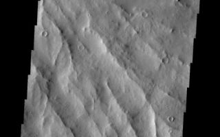<h1>PIA09984:  Apollinaris Patera</h1><div class="PIA09984" lang="en" style="width:546px;text-align:left;margin:auto;background-color:#000;padding:10px;max-height:150px;overflow:auto;"><p><a href="/figures/PIA09984_fig1.jpg"></a><br><b>Context image for PIA09984<br />Apollinaris Patera</b></p><p>The major Martian dust storm of 2007 filled the sky with dust and produced conditions that prevented the THEMIS VIS camera from being able to image the surface. With no new images being acquired, we've dug into the archive to highlight some interesting areas on Mars. The this week's region is Apollinaris Patera. Apollinaris Patera is an old volcano that has undergone extensive erosion. This volcano is located north of Gusev Crater, the home of the rover called Spirit. Today's image is of the eroded southeastern flank of the volcano.<p>Image information: VIS instrument. Latitude -9.7N, Longitude 175.1E. 18 meter/pixel resolution.</p><p>Please see the <a href="http://themis.asu.edu/terms" target="_blank">THEMIS Data Citation Note</a> for details on crediting THEMIS images.</p><p>Note: this THEMIS visual image has not been radiometrically nor geometrically calibrated for this preliminary release. An empirical correction has been performed to remove instrumental effects. A linear shift has been applied in the cross-track and down-track direction to approximate spacecraft and planetary motion. Fully calibrated and geometrically projected images will be released through the Planetary Data System in accordance with Project policies at a later time.</p><p>NASA's Jet Propulsion Laboratory manages the 2001 Mars Odyssey mission for NASA's Office of Space Science, Washington, D.C. The Thermal Emission Imaging System (THEMIS) was developed by Arizona State University, Tempe, in collaboration with Raytheon Santa Barbara Remote Sensing. The THEMIS investigation is led by Dr. Philip Christensen at Arizona State University. Lockheed Martin Astronautics, Denver, is the prime contractor for the Odyssey project, and developed and built the orbiter. Mission operations are conducted jointly from Lockheed Martin and from JPL, a division of the California Institute of Technology in Pasadena.</p><br /><br /><a href="http://photojournal.jpl.nasa.gov/catalog/PIA09984" onclick="window.open(this.href); return false;" title="Voir l'image 	 PIA09984:  Apollinaris Patera	  sur le site de la NASA">Voir l'image 	 PIA09984:  Apollinaris Patera	  sur le site de la NASA.</a></div>