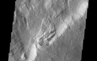 <h1>PIA10338:  Landslide</h1><div class="PIA10338" lang="en" style="width:572px;text-align:left;margin:auto;background-color:#000;padding:10px;max-height:150px;overflow:auto;"><p><a href="/figures/PIA10338_fig1.jpg"></a><br><b>Context image for PIA10338<br />Landslide</b></p><p>This landslide deposit is located on the northern side of Sharonov Crater, which has been modified by the flows within Kasei and Lobo Valles.<p>Image information: VIS instrument. Latitude 28.2N, Longitude 301.2E. 19 meter/pixel resolution.</p><p>Please see the <a href="http://themis.asu.edu/terms" target="_blank">THEMIS Data Citation Note</a> for details on crediting THEMIS images.</p><p>Note: this THEMIS visual image has not been radiometrically nor geometrically calibrated for this preliminary release. An empirical correction has been performed to remove instrumental effects. A linear shift has been applied in the cross-track and down-track direction to approximate spacecraft and planetary motion. Fully calibrated and geometrically projected images will be released through the Planetary Data System in accordance with Project policies at a later time.</p><p>NASA's Jet Propulsion Laboratory manages the 2001 Mars Odyssey mission for NASA's Office of Space Science, Washington, D.C. The Thermal Emission Imaging System (THEMIS) was developed by Arizona State University, Tempe, in collaboration with Raytheon Santa Barbara Remote Sensing. The THEMIS investigation is led by Dr. Philip Christensen at Arizona State University. Lockheed Martin Astronautics, Denver, is the prime contractor for the Odyssey project, and developed and built the orbiter. Mission operations are conducted jointly from Lockheed Martin and from JPL, a division of the California Institute of Technology in Pasadena.<br /><br /><a href="http://photojournal.jpl.nasa.gov/catalog/PIA10338" onclick="window.open(this.href); return false;" title="Voir l'image 	 PIA10338:  Landslide	  sur le site de la NASA">Voir l'image 	 PIA10338:  Landslide	  sur le site de la NASA.</a></div>