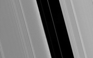 <h1>PIA10402:  Pan's Gap</h1><div class="PIA10402" lang="en" style="width:800px;text-align:left;margin:auto;background-color:#000;padding:10px;max-height:150px;overflow:auto;"><p>The Encke Gap in Saturn's A ring is maintained by the presence of the moon Pan, which shares the gap with several diffuse ringlets. The scalloped appearance in the inner (left side) edge of the gap results from perturbations caused by Pan as it sweeps through the 325-kilometer (200-mile) wide lane.</p><p>This view looks toward the sunlit side of the rings from about 38 degrees below the ringplane. The image was taken in visible light with the Cassini spacecraft narrow-angle camera on May 10, 2008. The view was acquired at a distance of approximately 264,000 kilometers (164,000 miles) from Saturn. Image scale is 1 kilometer (0.6 mile) per pixel.</p><p>The Cassini-Huygens mission is a cooperative project of NASA, the European Space Agency and the Italian Space Agency. The Jet Propulsion Laboratory, a division of the California Institute of Technology in Pasadena, manages the mission for NASA's Science Mission Directorate, Washington, D.C. The Cassini orbiter and its two onboard cameras were designed, developed and assembled at JPL. The imaging operations center is based at the Space Science Institute in Boulder, Colo.</p><p>For more information about the Cassini-Huygens mission visit <a href="http://saturn.jpl.nasa.gov" class="external free" target="wpext">http://saturn.jpl.nasa.gov/</a>. The Cassini imaging team homepage is at <a href="http://ciclops.org" class="external free" target="wpext">http://ciclops.org</a>.<br /><br /><a href="http://photojournal.jpl.nasa.gov/catalog/PIA10402" onclick="window.open(this.href); return false;" title="Voir l'image 	 PIA10402:  Pan's Gap	  sur le site de la NASA">Voir l'image 	 PIA10402:  Pan's Gap	  sur le site de la NASA.</a></div>