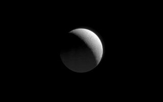 <h1>PIA10471:  Approaching Enceladus</h1><div class="PIA10471" lang="en" style="width:707px;text-align:left;margin:auto;background-color:#000;padding:10px;max-height:150px;overflow:auto;"><p>As the Cassini spacecraft began its August 2008 flyby of Enceladus, the spacecraft approached over the moon's cratered north pole. Cassini acquired this view as the icy moon grew ever larger in its field of view.</p><p>In addition to the sunlit crescent at upper right, the faint glow at bottom indicates a secondary source of illumination: reflected sunlight from Saturn.</p><p>The view looks toward high northern latitudes on Enceladus (504 kilometers, or 313 miles across) from a perspective 71 degrees north of the moon's equator. The north pole is in shadow at center.</p><p>The image was taken in visible light with the Cassini spacecraft narrow-angle camera on Aug. 11, 2008. The view was obtained at a distance of approximately 448,000 kilometers (278,000 miles) from Enceladus and at a Sun-Enceladus-spacecraft, or phase, angle of 113 degrees. Image scale at maximum resolution is 3 kilometers (2 miles) per pixel.</p><p>The Cassini-Huygens mission is a cooperative project of NASA, the European Space Agency and the Italian Space Agency. The Jet Propulsion Laboratory, a division of the California Institute of Technology in Pasadena, manages the mission for NASA's Science Mission Directorate, Washington, D.C. The Cassini orbiter and its two onboard cameras were designed, developed and assembled at JPL. The imaging operations center is based at the Space Science Institute in Boulder, Colo.</p><p>For more information about the Cassini-Huygens mission visit <a href="http://saturn.jpl.nasa.gov" class="external free" target="wpext">http://saturn.jpl.nasa.gov/</a>. The Cassini imaging team homepage is at <a href="http://ciclops.org" class="external free" target="wpext">http://ciclops.org</a>.<br /><br /><a href="http://photojournal.jpl.nasa.gov/catalog/PIA10471" onclick="window.open(this.href); return false;" title="Voir l'image 	 PIA10471:  Approaching Enceladus	  sur le site de la NASA">Voir l'image 	 PIA10471:  Approaching Enceladus	  sur le site de la NASA.</a></div>