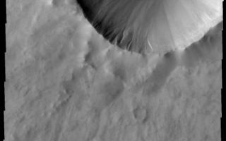 <h1>PIA10853:  Dunes and Gullies</h1><div class="PIA10853" lang="en" style="width:475px;text-align:left;margin:auto;background-color:#000;padding:10px;max-height:150px;overflow:auto;"><p><a href="/figures/PIA10853_fig1.jpg"></a><br><b>Context image for PIA10853<br />Dunes and Gullies</b></p><p>A small dune field covers the floor of this unnamed crater, while gullies are located on the interior of the western rim.<p>Image information: VIS instrument. Latitude 63.6N, Longitude 291.9E. 20 meter/pixel resolution.</p><p>Please see the <a href="http://themis.asu.edu/terms" target="_blank">THEMIS Data Citation Note</a> for details on crediting THEMIS images.</p><p>Note: this THEMIS visual image has not been radiometrically nor geometrically calibrated for this preliminary release. An empirical correction has been performed to remove instrumental effects. A linear shift has been applied in the cross-track and down-track direction to approximate spacecraft and planetary motion. Fully calibrated and geometrically projected images will be released through the Planetary Data System in accordance with Project policies at a later time.</p><p>NASA's Jet Propulsion Laboratory manages the 2001 Mars Odyssey mission for NASA's Office of Space Science, Washington, D.C. The Thermal Emission Imaging System (THEMIS) was developed by Arizona State University, Tempe, in collaboration with Raytheon Santa Barbara Remote Sensing. The THEMIS investigation is led by Dr. Philip Christensen at Arizona State University. Lockheed Martin Astronautics, Denver, is the prime contractor for the Odyssey project, and developed and built the orbiter. Mission operations are conducted jointly from Lockheed Martin and from JPL, a division of the California Institute of Technology in Pasadena.<br /><br /><a href="http://photojournal.jpl.nasa.gov/catalog/PIA10853" onclick="window.open(this.href); return false;" title="Voir l'image 	 PIA10853:  Dunes and Gullies	  sur le site de la NASA">Voir l'image 	 PIA10853:  Dunes and Gullies	  sur le site de la NASA.</a></div>