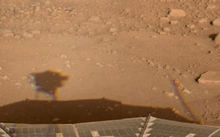 <h1>PIA10923:  Happy Mars Solstice!</h1><div class="PIA10923" lang="en" style="width:800px;text-align:left;margin:auto;background-color:#000;padding:10px;max-height:150px;overflow:auto;"><p>This image was acquired by NASA's Phoenix Mars Lander's Surface Stereo Imager (SSI) in the late afternoon of the 30th Martian day of the mission, or Sol 30 (June 25, 2008). This is hours after the beginning of Martian northern summer. SSI used its natural-color filters, therefore the color is the color you would see on Mars. The image shows shadows from the SSI (left) and from the meteorological station mast (right) stretching toward the east as the sun dropped low in the west. </p><p>The Phoenix Mission is led by the University of Arizona, Tucson, on behalf of NASA. Project management of the mission is led by NASA's Jet Propulsion Laboratory, Pasadena, Calif. Spacecraft development is by Lockheed Martin Space Systems, Denver<br /><br /><a href="http://photojournal.jpl.nasa.gov/catalog/PIA10923" onclick="window.open(this.href); return false;" title="Voir l'image 	 PIA10923:  Happy Mars Solstice!	  sur le site de la NASA">Voir l'image 	 PIA10923:  Happy Mars Solstice!	  sur le site de la NASA.</a></div>
