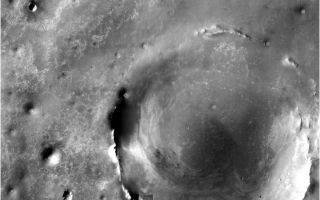<h1>PIA11185:  Bigger Crater Farther South of 'Victoria' on Mars</h1><div class="PIA11185" lang="en" style="width:800px;text-align:left;margin:auto;background-color:#000;padding:10px;max-height:150px;overflow:auto;"><p><a href="/figures/PIA11185_fig1.jpg" class="external free" target="wpext"></a><br />Annotated version</p><p>The team operating NASA's Mars Exploration Rover Opportunity has chosen southeast as the direction for the rover's next extended journey, toward a crater more than 20 times wider than "Victoria Crater." Opportunity exited Victoria Crater on Aug. 28, 2008, after nearly a year investigating the interior.</p><p>The crater to the southeast is about 22 kilometers (13.7 miles) in diameter and about 300 meters (1,000 feet) deep, exposing a much thicker stack of rock layers than those examined in Victoria Crater.</p><p>The rover team informally calls the bigger crater "Endeavour" and emphasizes that Opportunity may well never reach it. The rover has already operated more than 18 times longer than originally planned, and the distance to the big crater, about 12 kilometers (7 miles) matches the total distance Opportunity has driven since landing in early 2004. Driving southeastward is expected to take Opportunity to exposures of younger rock layers than is has previously seen and to provide access to rocks on the plain that were thrown long distances by impacts that excavated even deeper, more distant craters.</p><p>The crater that Opportunity will drive toward dominates this orbital view from the Thermal Emission Imaging System (THEMIS) camera on NASA's Mars Odyssey orbiter. The much smaller Victoria Crater is the most prominent circle near the upper left corner of the image. This view is a mosaic of about 50 separate visible-light images taken by THEMIS.</p><p>NASA's Jet Propulsion Laboratory manages the Mars Odyssey and Mars Exploration Rover missions for the NASA Science Mission Directorate, Washington, D.C. THEMIS was developed by Arizona State University, Tempe, in collaboration with Raytheon Santa Barbara Remote Sensing. The THEMIS investigation is led by Arizona State University. Lockheed Martin Astronautics, Denver, is the prime contractor for the Odyssey project, and developed and built the orbiter. Mission operations are conducted jointly from Lockheed Martin and from JPL, a division of the California Institute of Technology in Pasadena.<br /><br /><a href="http://photojournal.jpl.nasa.gov/catalog/PIA11185" onclick="window.open(this.href); return false;" title="Voir l'image 	 PIA11185:  Bigger Crater Farther South of 'Victoria' on Mars	  sur le site de la NASA">Voir l'image 	 PIA11185:  Bigger Crater Farther South of 'Victoria' on Mars	  sur le site de la NASA.</a></div>
