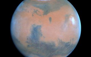 <h1>PIA01253:  Springtime on Mars: Hubble's Best View of the Red Planet</h1><div class="PIA01253" lang="en" style="width:800px;text-align:left;margin:auto;background-color:#000;padding:10px;max-height:150px;overflow:auto;"><p>This NASA Hubble Space Telescope view of the planet Mars was, at the time it was taken, the clearest picture ever taken from Earth, surpassed only by close-up shots sent back by visiting space probes. The picture was taken on February 25, 1995, when Mars was at a distance of approximately 65 million miles (103 million km) from Earth.<p>Because it is spring in Mars' northern hemisphere, much of the carbon dioxide frost around the permanent water-ice cap has sublimated, and the cap has receded to a core of solid water-ice several hundred miles across.<p>Towering 16 miles (25 km) above the surrounding plains, volcano Ascraeus Mons pokes above the cloud deck near the western or limb. This extinct volcano, measuring 250 miles (402 km) across, was discovered in the early 1970s by Mariner 9 spacecraft. Other key geologic features include (lower left) the Valles Marineris, an immense rift valley the length of the continental United States. Near the center of the disk lies the Chryse basin made up of cratered and chaotic terrain. The oval-looking Argyre impact basin (bottom), appears white due to clouds or frost.<p>Seasonal winds carry dust to form striking linear features reminiscent of the legendary martian "canals." Many of these "wind streaks" emanate from the bowl of these craters where dark coarse sand is swept out by winds. Hubble resolves several dozen impact craters down to 30-mile diameter. The dark areas, once misinterpreted as regions of vegetation by several early Mars watchers, are really areas of coarse sand that is less reflective than the finer, lighter dust. Seasonal changes in the surface appearance occur as winds move the dust and sand around.<p>This picture was taken with Hubble's Wide Field Planetary Camera 2 in PC mode. The pictures were map-projected onto a sphere for accurate registration and perspective.<p>This image and other images and data received from the Hubble Space Telescope are posted on the World Wide Web on the Space Telescope Science Institute home page at URL <a href="http://oposite.stsci.edu/" class="external free" target="wpext">http://oposite.stsci.edu/</a>.<br /><br /><a href="http://photojournal.jpl.nasa.gov/catalog/PIA01253" onclick="window.open(this.href); return false;" title="Voir l'image 	 PIA01253:  Springtime on Mars: Hubble's Best View of the Red Planet	  sur le site de la NASA">Voir l'image 	 PIA01253:  Springtime on Mars: Hubble's Best View of the Red Planet	  sur le site de la NASA.</a></div>