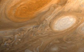 <h1>PIA01512:  Jupiter's Great Red Spot and White Ovals</h1><div class="PIA01512" lang="en" style="width:800px;text-align:left;margin:auto;background-color:#000;padding:10px;max-height:150px;overflow:auto;">This photo of Jupiter was taken by Voyager 1 on the evening of March 1, 1979, from a distance of 2.7 million miles (4.3 million kilometers). The photo shows Jupiter's Great Red Spot (top) and one of the white ovals than can be seen in Jupiter's atmosphere from Earth. The white ovals were seen to form in 1939, and 1940, and have remained more or less constant ever since. None of the structure and detail evident in these features have ever been seen from Earth. The Great Red Spot is three times as large as Earth. Also evident in the picture is a great deal of atmospheric detail that will require further study for interpretation. The smallest details that can be seen in this picture are about 45 miles (80 kilometers~ across. JPL manages and controls the Voyager project for NASA's Office of Space Science.<br /><br /><a href="http://photojournal.jpl.nasa.gov/catalog/PIA01512" onclick="window.open(this.href); return false;" title="Voir l'image 	 PIA01512:  Jupiter's Great Red Spot and White Ovals	  sur le site de la NASA">Voir l'image 	 PIA01512:  Jupiter's Great Red Spot and White Ovals	  sur le site de la NASA.</a></div>