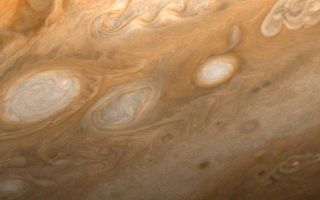 <h1>PIA01513:  Jupiter - Southeast of Great Red Spot</h1><div class="PIA01513" lang="en" style="width:800px;text-align:left;margin:auto;background-color:#000;padding:10px;max-height:150px;overflow:auto;">This photo of Jupiter was taken by Voyager 1 on March 1, 1979, from a distance of 2.7 million miles (4.3 million kilometers). The region shown is just to the southeast of the Great Red Spot. A small section of the spot can be seen at upper left. One of the 40-year-old white ovals in Jupiter's atmosphere can also be seen at middle left, as well as a wealth of other atmospheric features, including the flow lines in and around the ovals. The smallest details that can be seen in this photo are about 45 miles (80 kilometers) across. JPL manages and controls the Voyager project for NASA's Office of Space Science.<br /><br /><a href="http://photojournal.jpl.nasa.gov/catalog/PIA01513" onclick="window.open(this.href); return false;" title="Voir l'image 	 PIA01513:  Jupiter - Southeast of Great Red Spot	  sur le site de la NASA">Voir l'image 	 PIA01513:  Jupiter - Southeast of Great Red Spot	  sur le site de la NASA.</a></div>