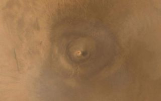 <h1>PIA03470:  Arsia Mons Spiral Cloud</h1><div class="PIA03470" lang="en" style="width:800px;text-align:left;margin:auto;background-color:#000;padding:10px;max-height:150px;overflow:auto;"><p>One of the benefits of the Mars Global Surveyor (MGS) Mars Orbiter Camera (MOC) Extended Mission is the opportunity to observe how the planet's weather changes during a second full martian year. This picture of Arsia Mons was taken June 19, 2001; southern spring equinox occurred the same day. Arsia Mons is a volcano nearly large enough to cover the state of New Mexico. On this particular day (the first day of Spring), the MOC wide angle cameras documented an unusual spiral-shaped cloud within the 110 km (68 mi) diameter caldera--the summit crater--of the giant volcano. Because the cloud is bright both in the red and blue images acquired by the wide angle cameras, it probably consisted mostly of fine dust grains. The cloud's spin may have been induced by winds off the inner slopes of the volcano's caldera walls resulting from the temperature differences between the walls and the caldera floor, or by a vortex as winds blew up and over the caldera. Similar spiral clouds were seen inside the caldera for several days; we don't know if this was a single cloud that persisted throughout that time or one that regenerated each afternoon. Sunlight illuminates this scene from the left/upper left.<p>Malin Space Science Systems and the California Institute of Technology built the MOC using spare hardware from the Mars Observer mission. MSSS operates the camera from its facilities in San Diego, CA. The Jet Propulsion Laboratory's Mars Surveyor Operations Project operates the Mars Global Surveyor spacecraft with its industrial partner, Lockheed Martin Astronautics, from facilities in Pasadena, CA and Denver, CO.<br /><br /><a href="http://photojournal.jpl.nasa.gov/catalog/PIA03470" onclick="window.open(this.href); return false;" title="Voir l'image 	 PIA03470:  Arsia Mons Spiral Cloud	  sur le site de la NASA">Voir l'image 	 PIA03470:  Arsia Mons Spiral Cloud	  sur le site de la NASA.</a></div>