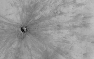 <h1>PIA04809:  Fresh Impact Crater</h1><div class="PIA04809" lang="en" style="width:799px;text-align:left;margin:auto;background-color:#000;padding:10px;max-height:150px;overflow:auto;">MGS MOC Release No. MOC2-522, 23 October 2003<p />This Mars Global Surveyor (MGS) Mars Orbiter Camera (MOC) picture shows a young, fresh meteor impact crater in southeast Arabia Terra acquired in August 2003. The crater is inferred to be young because it still has a finely detailed pattern of rays associated with its ejecta. These rays formed in a dusty mantle that covers the other craters and rocky terrain at this locale. The crater is young enough that there has not been sufficient time for new dust to cover the rays, or for winds to erase them. The small dark dots associated with the crater are boulders. The boulders were ejected by the impact event. This crater is located near 6.9°S, 317.1°W. The picture covers an area approximately 3 km (1.9 mi) wide and is illuminated by sunlight from the lower left.<br /><br /><a href="http://photojournal.jpl.nasa.gov/catalog/PIA04809" onclick="window.open(this.href); return false;" title="Voir l'image 	 PIA04809:  Fresh Impact Crater	  sur le site de la NASA">Voir l'image 	 PIA04809:  Fresh Impact Crater	  sur le site de la NASA.</a></div>