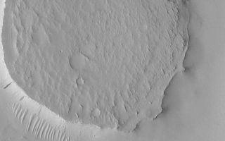 <h1>PIA04860:  Circular Mesa</h1><div class="PIA04860" lang="en" style="width:800px;text-align:left;margin:auto;background-color:#000;padding:10px;max-height:150px;overflow:auto;">MGS MOC Release No. MOC2-538, 8 November 2003<p />This Mars Global Surveyor (MGS) Mars Orbiter Camera (MOC) image shows a circular mesa in northeast Arabia Terra. The circularity suggests that this landform might be similar to other circular mesas, found elsewhere on Mars. In those other cases, the mesa was once a meteor impact crater. The crater was filled with sediment, the sediment was cemented to become rock, and later erosion removed all of the material surrounding the former crater, leaving it standing alone as a circular mesa. This image is located near 23.7°N, 319.0°W, and covers an area 3 km (1.9 mi) wide. The scene is illuminated by sunlight from the left.<br /><br /><a href="http://photojournal.jpl.nasa.gov/catalog/PIA04860" onclick="window.open(this.href); return false;" title="Voir l'image 	 PIA04860:  Circular Mesa	  sur le site de la NASA">Voir l'image 	 PIA04860:  Circular Mesa	  sur le site de la NASA.</a></div>