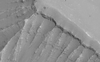 <h1>PIA04867:  Ius Chasma Layers</h1><div class="PIA04867" lang="en" style="width:800px;text-align:left;margin:auto;background-color:#000;padding:10px;max-height:150px;overflow:auto;">MGS MOC Release No. MOC2-542, 12 November 2003<p />Outcrops of layered rock abound in the "grand canyon of Mars," the Valles Marineris. This Mars Global Surveyor (MGS) Mars Orbiter Camera (MOC) image provides an example from the upper northeast wall of Ius Chasma. This picture is located near 7.7°S, 76.1°W. The picture is 3 km (1.9 mi) wide and illuminated by sunlight from the lower right.<br /><br /><a href="http://photojournal.jpl.nasa.gov/catalog/PIA04867" onclick="window.open(this.href); return false;" title="Voir l'image 	 PIA04867:  Ius Chasma Layers	  sur le site de la NASA">Voir l'image 	 PIA04867:  Ius Chasma Layers	  sur le site de la NASA.</a></div>