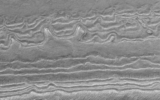 <h1>PIA04877:  South Polar Layers</h1><div class="PIA04877" lang="en" style="width:672px;text-align:left;margin:auto;background-color:#000;padding:10px;max-height:150px;overflow:auto;">MGS MOC Release No. MOC2-548, 18 November 2003<p />The south polar region of Mars exhibits thick exposures of layered sediment. This Mars Global Surveyor (MGS) Mars Orbiter Camera (MOC) picture shows an example of layers exposed on a slope. The image was obtained during southern summer in early November 2003. Sunlight illuminates the layers from the upper left; the lowest layers are at the top of the image; the slope goes up-hill toward the bottom. This area is located near 86.0°S, 182.4°W, and covers an area approximately 3 km (1.9 mi) wide.<br /><br /><a href="http://photojournal.jpl.nasa.gov/catalog/PIA04877" onclick="window.open(this.href); return false;" title="Voir l'image 	 PIA04877:  South Polar Layers	  sur le site de la NASA">Voir l'image 	 PIA04877:  South Polar Layers	  sur le site de la NASA.</a></div>