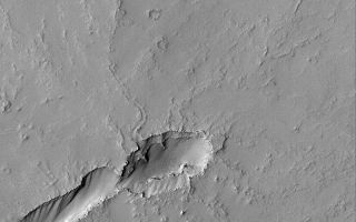 <h1>PIA04880:  Volcano Near Pavonis Mons</h1><div class="PIA04880" lang="en" style="width:800px;text-align:left;margin:auto;background-color:#000;padding:10px;max-height:150px;overflow:auto;">MGS MOC Release No. MOC2-549, 19 November 2003<p />The volcanic plains to the east, southeast, and south of the giant Tharsis volcano, Pavonis Mons, are dotted by dozens of small volcanoes. This Mars Global Surveyor (MGS) Mars Orbiter Camera (MOC) image shows an example located near 2.1°S, 109.1°W. The elongate depression in the lower left (southwest) quarter of the image is the collapsed vent area for this small, unnamed volcano. A slightly sinuous, leveed channel runs from the depression toward the upper right (north-northeast); this is the trace of a collapsed lava tube. The entire scene has been mantled by dust, such that none of the original volcanic rocks are exposed--except minor occurrences on the steepest slopes in the vent area. The scene is 3 km (1.9 mi) wide and illuminated by sunlight from the left/upper left.<br /><br /><a href="http://photojournal.jpl.nasa.gov/catalog/PIA04880" onclick="window.open(this.href); return false;" title="Voir l'image 	 PIA04880:  Volcano Near Pavonis Mons	  sur le site de la NASA">Voir l'image 	 PIA04880:  Volcano Near Pavonis Mons	  sur le site de la NASA.</a></div>