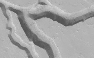 <h1>PIA04887:  Iberus Vallis Troughs</h1><div class="PIA04887" lang="en" style="width:800px;text-align:left;margin:auto;background-color:#000;padding:10px;max-height:150px;overflow:auto;">MGS MOC Release No. MOC2-553, 23 November 2003<p />Iberus Vallis is a trough system located radial to and southeast of the martian volcano, Elysium Mons. This Mars Global Surveyor (MGS) Mars Orbiter Camera (MOC) image, acquired in October 2003, shows some of the valleys of this region; they are cut into what is presumably (at least near the top) volcanic rock. The dark dots and specks on the valley floors are large boulders that have been shed from the slopes. This picture is located near 21.6°N, 208.3°W. The image shows an area 3 km (1.9 mi) wide, and is illuminated by sunlight from the lower left.<br /><br /><a href="http://photojournal.jpl.nasa.gov/catalog/PIA04887" onclick="window.open(this.href); return false;" title="Voir l'image 	 PIA04887:  Iberus Vallis Troughs	  sur le site de la NASA">Voir l'image 	 PIA04887:  Iberus Vallis Troughs	  sur le site de la NASA.</a></div>