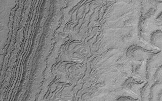 <h1>PIA04898:  South Polar Layered Slope</h1><div class="PIA04898" lang="en" style="width:672px;text-align:left;margin:auto;background-color:#000;padding:10px;max-height:150px;overflow:auto;">MGS MOC Release No. MOC2-559, 29 November 2003<p />Both the north and south polar regions of Mars exhibit thick deposits of layered sediment. These have been known since the Mariner 9 (1972) and Viking (1976-1980) orbiter missions. The layered deposits are considered to contain a record of climate changes that occurred in the relatively recent martian past, but most of that record will have to wait until some time in the future when a lander or people can go there to study them. Meanwhile, pictures such as this from the Mars Global Surveyor (MGS) Mars Orbiter Camera (MOC) provide opportunities to view the layers where they are exposed on slopes. Here, numerous layers have been exposed by erosion in the south polar region. The picture was obtained in October 2003 and is located near 86.4°S, 112.4°W. The image covers an area 3 km (1.9 mi) wide, and is illuminated by sunlight from the upper left.<br /><br /><a href="http://photojournal.jpl.nasa.gov/catalog/PIA04898" onclick="window.open(this.href); return false;" title="Voir l'image 	 PIA04898:  South Polar Layered Slope	  sur le site de la NASA">Voir l'image 	 PIA04898:  South Polar Layered Slope	  sur le site de la NASA.</a></div>