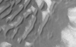 <h1>PIA04899:  South Polar Sand Dunes</h1><div class="PIA04899" lang="en" style="width:800px;text-align:left;margin:auto;background-color:#000;padding:10px;max-height:150px;overflow:auto;">MGS MOC Release No. MOC2-560, 30 November 2003<p />This October 2003 Mars Global Surveyor (MGS) Mars Orbiter Camera (MOC) image shows sand dunes in the southern high latitudes of Mars. Unlike dunes at more northerly latitudes, south polar dunes tend to lack sharp, crisp features. Instead, they are often rounded, smoothed, and, in some cases (as toward the lower 1/3 of this image), flattened. These observations suggest that south polar dunes may be somewhat cemented and are presently (or fairly recently in the past) undergoing erosion. This dune field is located near 63.7°S, 201.2°W. The image covers an area 3 km (1.9 mi) wide, and is illuminated by sunlight from the upper left.<br /><br /><a href="http://photojournal.jpl.nasa.gov/catalog/PIA04899" onclick="window.open(this.href); return false;" title="Voir l'image 	 PIA04899:  South Polar Sand Dunes	  sur le site de la NASA">Voir l'image 	 PIA04899:  South Polar Sand Dunes	  sur le site de la NASA.</a></div>