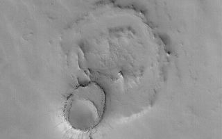 <h1>PIA04904:  Exhuming Crater in Northeast Arabia</h1><div class="PIA04904" lang="en" style="width:799px;text-align:left;margin:auto;background-color:#000;padding:10px;max-height:150px;overflow:auto;">MGS MOC Release No. MOC2-563, 3 December 2003<p />The upper crust of Mars is layered, and interbedded with these layers are old, filled and buried meteor impact craters. In a few places on Mars, such as Arabia Terra, erosion has re-exposed some of the filled and buried craters. This October 2003 Mars Global Surveyor (MGS) Mars Orbiter Camera (MOC) image shows an example. The larger circular feature was once a meteor crater. It was filled with sediment, then buried beneath younger rocks. The smaller circular feature is a younger impact crater that formed in the surface above the rocks that buried the large crater. Later, erosion removed all of the material that covered the larger, buried crater, except in the location of the small crater. This pair of martian landforms is located near 17.6°N, 312.8°W. The image covers an area 3 km (1.9 mi) wide and is illuminated from the lower left.<br /><br /><a href="http://photojournal.jpl.nasa.gov/catalog/PIA04904" onclick="window.open(this.href); return false;" title="Voir l'image 	 PIA04904:  Exhuming Crater in Northeast Arabia	  sur le site de la NASA">Voir l'image 	 PIA04904:  Exhuming Crater in Northeast Arabia	  sur le site de la NASA.</a></div>