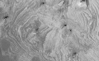 <h1>PIA04911:  Tithonium Chasma's Sedimentary Rocks</h1><div class="PIA04911" lang="en" style="width:800px;text-align:left;margin:auto;background-color:#000;padding:10px;max-height:150px;overflow:auto;">MGS MOC Release No. MOC2-565, 5 December 2003<p />Exposures of light-toned, layered, sedimentary rocks are common in the deep troughs of the Valles Marineris system. This Mars Global Surveyor (MGS) Mars Orbiter Camera (MOC) image shows an example from western Tithonium Chasma. The banding seen here is an eroded expression of layered rock. Sedimentary rocks can be composed of (1) the detritus of older, eroded and weathered rocks, (2) grains produced by explosive volcanism (tephra, also known as volcanic ash), or (3) minerals that were chemically precipitated out of a body of liquid such as water. These outcrops are located near 4.8°S, 89.7°W. The image covers an area 3 km (1.9 mi) wide and is illuminated from the lower left.<br /><br /><a href="http://photojournal.jpl.nasa.gov/catalog/PIA04911" onclick="window.open(this.href); return false;" title="Voir l'image 	 PIA04911:  Tithonium Chasma's Sedimentary Rocks	  sur le site de la NASA">Voir l'image 	 PIA04911:  Tithonium Chasma's Sedimentary Rocks	  sur le site de la NASA.</a></div>