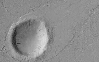 <h1>PIA04912:  Crater in Marte Vallis</h1><div class="PIA04912" lang="en" style="width:512px;text-align:left;margin:auto;background-color:#000;padding:10px;max-height:150px;overflow:auto;">MGS MOC Release No. MOC2-566, 6 December 2003<p />This Mars Global Surveyor (MGS) Mars Orbiter Camera (MOC) image shows a streamlined tail-pointing toward the upper right (northeast)--in the lee of a meteor impact crater in Marte Vallis, a large valley and channel complex southeast and east of the Elysium volcanic region. The fluid that went through Marte Vallis, whether water, mud, lava, or otherwise, created this form as it moved from the lower left (southwest) toward the upper right. The crater is located near 19.0°N, 174.9°W. The image covers an area 3 km (1.9 mi) wide and is illuminated from the left.<br /><br /><a href="http://photojournal.jpl.nasa.gov/catalog/PIA04912" onclick="window.open(this.href); return false;" title="Voir l'image 	 PIA04912:  Crater in Marte Vallis	  sur le site de la NASA">Voir l'image 	 PIA04912:  Crater in Marte Vallis	  sur le site de la NASA.</a></div>