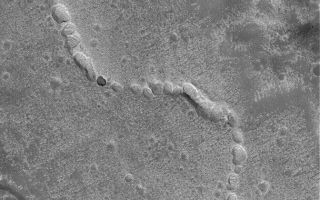 <h1>PIA05790:  Collapsed Subsurface Channel</h1><div class="PIA05790" lang="en" style="width:672px;text-align:left;margin:auto;background-color:#000;padding:10px;max-height:150px;overflow:auto;"><p>16 April 2004<br />This Mars Global Surveyor (MGS) Mars Orbiter Camera (MOC) image shows evidence of a collapsed lava tube (or other form of subterranean channel)on the plains northwest of the Elysium volcanoes. Lava or another fluid (e.g., water) was transported through a subsurface channel; later, the roof collapsed to form a series of pits and troughs, revealing the channel's location. This landform is located near 32.7°N, 219.5°W. The image covers an area about 3 km (1.9 mi) across. Sunlight illuminates the scene from the lower left.</p><br /><br /><a href="http://photojournal.jpl.nasa.gov/catalog/PIA05790" onclick="window.open(this.href); return false;" title="Voir l'image 	 PIA05790:  Collapsed Subsurface Channel	  sur le site de la NASA">Voir l'image 	 PIA05790:  Collapsed Subsurface Channel	  sur le site de la NASA.</a></div>