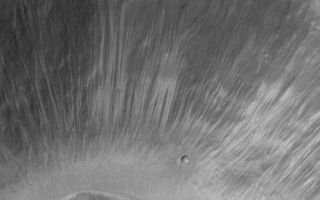<h1>PIA05858:  Alcoves in a Xanthe Crater</h1><div class="PIA05858" lang="en" style="width:581px;text-align:left;margin:auto;background-color:#000;padding:10px;max-height:150px;overflow:auto;"><p>3 May 2004<br />Martian middle- and polar-latitude gullies are not the only places that 'alcoves' form by downslope erosion of debris. Even at equatorial latitudes, some craters exhibit these features. Alcoves at the heads of narrow, dry landslide scars are indicated in this Mars Global Surveyor (MGS) Mars Orbiter Camera (MOC) image of a crater wall in Xanthe Terra. In both the middle/polar-latitude gully cases and in this example, alcoves form by undermining and collapse of material high on a relatively steep slope such as a crater wall. In this case, however, no fluid was involved, thus no gully or distinct apron formed. This crater wall is located near Shalbatana Vallis around 2.7°N, 43.1°W. The image is illuminated from the left; the 400 meter scale bar is about 437 yards long. For comparison, an example of martian gullies with alcoves, channels, and aprons can be seen in: Evidence for Recent Liquid Water on Mars: Basic Features of Martian Gullies, 22 June 2000; see <a href="/catalog/PIA01031">PIA01031</a>.</p><br /><br /><a href="http://photojournal.jpl.nasa.gov/catalog/PIA05858" onclick="window.open(this.href); return false;" title="Voir l'image 	 PIA05858:  Alcoves in a Xanthe Crater	  sur le site de la NASA">Voir l'image 	 PIA05858:  Alcoves in a Xanthe Crater	  sur le site de la NASA.</a></div>