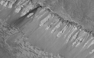 <h1>PIA05914:  Rock Slide in Ophir</h1><div class="PIA05914" lang="en" style="width:512px;text-align:left;margin:auto;background-color:#000;padding:10px;max-height:150px;overflow:auto;"><p>7 May 2004<br />The dark streaks, just left of center, on the steep slope in this Mars Global Surveyor (MGS) Mars Orbiter Camera (MOC) image were formed by a relatively recent rock slide. The streak closest to the center of the image resolves into a series of small depressions, indicating the path of a large, rolling boulder. The rock slide is inferred to have been recent (i.e., within the past several Mars years) because it is so much darker than its surroundings--there has not been sufficient time for the streak surfaces to become mantled by dust. The other talus accumulations on this slope are most likely lighter in tone because they are older and coated with dust. These features are located in Ophir Chasma, part of the Valles Marineris trough system, near 4.2°S, 74.0°W. The picture is illuminated by sunlight from the lower left and covers an area about 3 km (1.9 mi) across.</p><br /><br /><a href="http://photojournal.jpl.nasa.gov/catalog/PIA05914" onclick="window.open(this.href); return false;" title="Voir l'image 	 PIA05914:  Rock Slide in Ophir	  sur le site de la NASA">Voir l'image 	 PIA05914:  Rock Slide in Ophir	  sur le site de la NASA.</a></div>