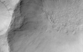<h1>PIA05915:  Martian Gullies</h1><div class="PIA05915" lang="en" style="width:800px;text-align:left;margin:auto;background-color:#000;padding:10px;max-height:150px;overflow:auto;"><p>8 May 2004<br />This March 2004 Mars Global Surveyor (MGS) Mars Orbiter Camera (MOC) image shows a gullied crater wall at southern mid-latitude near 35.5°S, 223.0°W. Formation of such gullies might have involved flowing liquid water. The Mars science community has been debating, since they were first reported in June 2000, whether such gullies were carved by water, carbon dioxide, or perhaps formed in completely dry, granular material without the influence of a fluid. The scientists have also debated whether the water--if it was water--started out in the form of ground ice, a snow pack, or liquid groundwater. Since June 2000, many hundreds of new gully locations--and tens of thousands of individual gullies--have been identified. Their relative youth suggests to some the possibility that Mars today has water or ice within less than 1 kilometer of the surface--a depth that may be readily accessible to future explorers. This picture is illuminated by sunlight from the upper left and covers an area about 3 km (1.9 mi) across.</p><br /><br /><a href="http://photojournal.jpl.nasa.gov/catalog/PIA05915" onclick="window.open(this.href); return false;" title="Voir l'image 	 PIA05915:  Martian Gullies	  sur le site de la NASA">Voir l'image 	 PIA05915:  Martian Gullies	  sur le site de la NASA.</a></div>