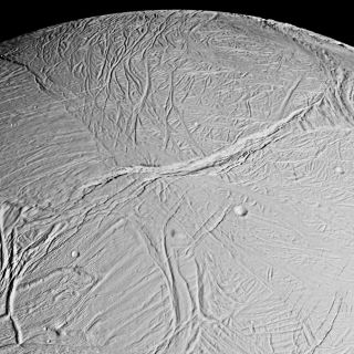 <h1>PIA06191:  Enceladus Mosaic</h1><div class="PIA06191" lang="en" style="width:800px;text-align:left;margin:auto;background-color:#000;padding:10px;max-height:150px;overflow:auto;"><p><a href="/figures/PIA06191_fig1.jpg"></a><br>Figure 1: Originally Released Image</p><p>This spectacular view is a mosaic of four high resolution images taken by the Cassini spacecraft narrow angle camera on Feb. 16, 2005, during its close flyby of Saturn's moon Enceladus.</p><p>The view is about 300 kilometers (200 miles) across and shows the myriad of faults, fractures, folds, troughs and craters that make this Saturnian satellite especially intriguing to planetary scientists. More than 20 years ago, NASA's Voyager spacecraft gave hints of a surface cut by tectonic features, and subsequent images of other icy moons have revealed many different ways that stresses have acted on icy moon crusts.</p><p>The new close-up images of Enceladus, which has a diameter of 505 kilometers (314 miles), show some familiar-looking features and others that are brand new. The work required to unravel their origins, their formation sequence, and the implications for the evolution of icy solar system bodies is just beginning.</p><p>Voyager images of Enceladus, which were obtained at much poorer spatial resolution, showed terrains like those seen here. They were called "smooth plains" because they appeared to exhibit little topographic relief. However, Cassini has now viewed these terrains at almost 10 times better resolution. The new images reveal very complex systems of fractures, resurfaced terrain, and in some cases, topographic relief greater than several hundred meters. </p><p>Many styles of fracturing are evident in this mosaic. Extending downward from the top center of the mosaic for hundreds of kilometers is a broad belt of complex, interwoven fractures. A huge rift 5 kilometers (3 miles)-wide dissects this belt and extends into several older-looking, distinct regions or "cells" of terrain that themselves exhibit distinct fracture patterns.<p>Because Cassini flew rapidly past Enceladus, the right-side images were taken from a slightly different perspective than the left, and are delineated by the white box.</p><p>The mosaic covers longitudes from about 254 west to 296 west and latitudes from 60 south to the equator.</p><p>The images were taken in visible light on Feb. 17, 2005, at distances ranging from of 26,140 to 17,434 kilometers (16,243 to 10,833 miles) from Enceladus and at Sun-Enceladus-spacecraft, or phase, angles ranging from 27 to 29 degrees. Pixel scale in the left-side image is 150 meters (492 feet) per pixel; in the right-side (white box) image, scale is 105 meters (344 feet) per pixel. The image has been contrast-enhanced to aid visibility. </p><p>The Cassini-Huygens mission is a cooperative project of NASA, the European Space Agency and the Italian Space Agency. The Jet Propulsion Laboratory, a division of the California Institute of Technology in Pasadena, manages the mission for NASA's Science Mission Directorate, Washington, D.C. The Cassini orbiter and its two onboard cameras were designed, developed and assembled at JPL. The imaging team is based at the Space Science Institute, Boulder, Colo.</p><p>For more information about the Cassini-Huygens mission, visit <a href="http://saturn.jpl.nasa.gov">http://saturn.jpl.nasa.gov</a> and the Cassini imaging team home page, <a href="http://ciclops.org">http://ciclops.org</a>.</p><br /><br /><a href="http://photojournal.jpl.nasa.gov/catalog/PIA06191" onclick="window.open(this.href); return false;" title="Voir l'image 	 PIA06191:  Enceladus Mosaic	  sur le site de la NASA">Voir l'image 	 PIA06191:  Enceladus Mosaic	  sur le site de la NASA.</a></div>