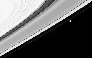 <h1>PIA06588:  String of Moons?</h1><div class="PIA06588" lang="en" style="width:800px;text-align:left;margin:auto;background-color:#000;padding:10px;max-height:150px;overflow:auto;"><p>Three of Saturn's moons appear almost like a string of pearls in this Cassini image, but looks are deceiving. </p><p>Moons visible in this image: Mimas (398 kilometers, or 247 miles across) at right, Pandora (84 kilometers, or 52 miles across) near center and Janus (181 kilometers, or 113 miles across) in the lower left corner. Mimas' orbit inclination of 1.6 degrees relative to Saturn's equator is enough to make it appear as if it orbits just beyond the F ring when viewed from this vantage point of 5 degrees below the rings. In fact, it is 34,000 kilometers (21,000 miles) more distant than Janus.</p><p>Contrast in the image was enhanced to make visible the faces of moons lit by reflected light from Saturn (their left sides). Notable here is the irregular shape of Janus, compared with larger, spherical Mimas. The bright B ring (at upper left) appears overexposed due to the extreme contrast enhancement.</p><p>The image was taken in visible light with the Cassini spacecraft narrow angle camera on Jan. 22, 2005, at a distance of approximately 2.7 million kilometers (1.7 million miles) from Saturn. The image scale is 16 kilometers (10 miles) per pixel.</p><p>The Cassini-Huygens mission is a cooperative project of NASA, the European Space Agency and the Italian Space Agency. The Jet Propulsion Laboratory, a division of the California Institute of Technology in Pasadena, manages the mission for NASA's Science Mission Directorate, Washington, D.C. The Cassini orbiter and its two onboard cameras were designed, developed and assembled at JPL. The imaging team is based at the Space Science Institute, Boulder, Colo.</p><p>For more information about the Cassini-Huygens mission, visit <a href="http://saturn.jpl.nasa.gov">http://saturn.jpl.nasa.gov</a> and the Cassini imaging team home page, <a href="http://ciclops.org">http://ciclops.org</a>.</p><br /><br /><a href="http://photojournal.jpl.nasa.gov/catalog/PIA06588" onclick="window.open(this.href); return false;" title="Voir l'image 	 PIA06588:  String of Moons?	  sur le site de la NASA">Voir l'image 	 PIA06588:  String of Moons?	  sur le site de la NASA.</a></div>