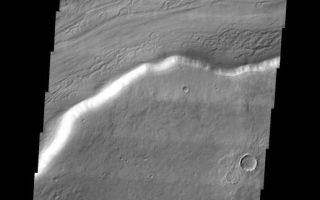 <h1>PIA06951:  Reull Vallis</h1><div class="PIA06951" lang="en" style="width:517px;text-align:left;margin:auto;background-color:#000;padding:10px;max-height:150px;overflow:auto;"><a href="/figures/PIA06951_fig1.jpg"> </a><br /><p>This week we will be examining images of Reull Vallis. Reull Vallis is located in the Martian southern highlands, just east of Hellas Basin. This extensive channel system records an interesting fluvial and mass wasting geologic history of the area. In many images show interesting patterns of mass wasted material in the bottom of the channel. For more information on the geology of Reull Vallis see <a href="http://viking.eps.pitt.edu/public/IcarusPub/Geol_RVR_Icarus.html">http://viking.eps.pitt.edu/public/IcarusPub/Geol_RVR_Icarus.html</a>.</p><p>Image information:VIS instrument. Latitude -41.8, Longitude 106 East (254 West). 19 meter/pixel resolution.</p><p>Note: this THEMIS visual image has not been radiometrically nor geometrically calibrated for this preliminary release. An empirical correction has been performed to remove instrumental effects. A linear shift has been applied in the cross-track and down-track direction to approximate spacecraft and planetary motion. Fully calibrated and geometrically projected images will be released through the Planetary Data System in accordance with Project policies at a later time.</p><p>NASA's Jet Propulsion Laboratory manages the 2001 Mars Odyssey mission for NASA's Office of Space Science, Washington, D.C. The Thermal Emission Imaging System (THEMIS) was developed by Arizona State University, Tempe, in collaboration with Raytheon Santa Barbara Remote Sensing. The THEMIS investigation is led by Dr. Philip Christensen at Arizona State University. Lockheed Martin Astronautics, Denver, is the prime contractor for the Odyssey project, and developed and built the orbiter. Mission operations are conducted jointly from Lockheed Martin and from JPL, a division of the California Institute of Technology in Pasadena.</p><br /><br /><a href="http://photojournal.jpl.nasa.gov/catalog/PIA06951" onclick="window.open(this.href); return false;" title="Voir l'image 	 PIA06951:  Reull Vallis	  sur le site de la NASA">Voir l'image 	 PIA06951:  Reull Vallis	  sur le site de la NASA.</a></div>