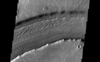 <h1>PIA06968:  Reull Vallis</h1><div class="PIA06968" lang="en" style="width:518px;text-align:left;margin:auto;background-color:#000;padding:10px;max-height:150px;overflow:auto;"><a href="/figures/PIA06968_fig1.jpg"> </a><br /><p>This week we will be examining images of Reull Vallis. Reull Vallis is located in the Martian southern highlands, just east of Hellas Basin. This extensive channel system records an interesting fluvial and mass wasting geologic history of the area. In many images show interesting patterns of mass wasted material in the bottom of the channel. For more information on the geology of Reull Vallis see <a href="http://viking.eps.pitt.edu/public/IcarusPub/Geol_RVR_Icarus.html">http://viking.eps.pitt.edu/public/IcarusPub/Geol_RVR_Icarus.html</a>.</p><p>Image information:VIS instrument. Latitude -41.4, Longitude 107 East (253 West). 19 meter/pixel resolution.</p><p>Note: this THEMIS visual image has not been radiometrically nor geometrically calibrated for this preliminary release. An empirical correction has been performed to remove instrumental effects. A linear shift has been applied in the cross-track and down-track direction to approximate spacecraft and planetary motion. Fully calibrated and geometrically projected images will be released through the Planetary Data System in accordance with Project policies at a later time.</p><p>NASA's Jet Propulsion Laboratory manages the 2001 Mars Odyssey mission for NASA's Office of Space Science, Washington, D.C. The Thermal Emission Imaging System (THEMIS) was developed by Arizona State University, Tempe, in collaboration with Raytheon Santa Barbara Remote Sensing. The THEMIS investigation is led by Dr. Philip Christensen at Arizona State University. Lockheed Martin Astronautics, Denver, is the prime contractor for the Odyssey project, and developed and built the orbiter. Mission operations are conducted jointly from Lockheed Martin and from JPL, a division of the California Institute of Technology in Pasadena.</p><br /><br /><a href="http://photojournal.jpl.nasa.gov/catalog/PIA06968" onclick="window.open(this.href); return false;" title="Voir l'image 	 PIA06968:  Reull Vallis	  sur le site de la NASA">Voir l'image 	 PIA06968:  Reull Vallis	  sur le site de la NASA.</a></div>