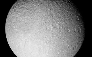 <h1>PIA07738:  Tethys in Full View</h1><div class="PIA07738" lang="en" style="width:800px;text-align:left;margin:auto;background-color:#000;padding:10px;max-height:150px;overflow:auto;"><p>With this full-disk mosaic, Cassini presents the best view yet of the south pole of Saturn's moon Tethys. </p><p>The giant rift Ithaca Chasma cuts across the disk. Much of the topography seen here, including that of Ithaca Chasma, has a soft, muted appearance. It is clearly very old and has been heavily bombarded by impacts over time.</p><p>Many of the fresh-appearing craters (ones with crisp relief) exhibit unusually bright crater floors. The origin of the apparent brightness (or "albedo") contrast is not known. It is possible that impacts punched through to a brighter layer underneath, or perhaps it is brighter because of different grain sizes or textures of the crater floor material in comparison to material along the crater walls and surrounding surface.</p><p>The moon's high southern latitudes, seen here at the bottom, were not imaged by NASA's Voyager spacecraft during their flybys of Tethys 25 years ago.</p><p>The mosaic is composed of nine images taken during Cassini's close flyby of Tethys (1,071 kilometers, or 665 miles across) on Sept. 24, 2005, during which the spacecraft passed approximately 1,500 kilometers (930 miles) above the moon's surface.</p><p>This view is centered on terrain at approximately 1.2 degrees south latitude and 342 degrees west longitude on Tethys. It has been rotated so that north is up.</p><p>The clear filter images in this mosaic were taken with the Cassini spacecraft narrow-angle camera at distances ranging from 71,600 kilometers (44,500 miles) to 62,400 kilometers (38,800 miles) from Tethys and at a Sun-Tethys-spacecraft, or phase, angle of 21 degrees. The image scale is 370 meters (1,200 feet) per pixel. </p><p>The Cassini-Huygens mission is a cooperative project of NASA, the European Space Agency and the Italian Space Agency. The Jet Propulsion Laboratory, a division of the California Institute of Technology in Pasadena, manages the mission for NASA's Science Mission Directorate, Washington, D.C. The Cassini orbiter and its two onboard cameras were designed, developed and assembled at JPL. The imaging operations center is based at the Space Science Institute in Boulder, Colo.</p><p>For more information about the Cassini-Huygens mission visit <a href="http://saturn.jpl.nasa.gov">http://saturn.jpl.nasa.gov</a>. For additional images visit the Cassini imaging team homepage <a href="http://ciclops.org">http://ciclops.org</a>.</p><br /><br /><a href="http://photojournal.jpl.nasa.gov/catalog/PIA07738" onclick="window.open(this.href); return false;" title="Voir l'image 	 PIA07738:  Tethys in Full View	  sur le site de la NASA">Voir l'image 	 PIA07738:  Tethys in Full View	  sur le site de la NASA.</a></div>