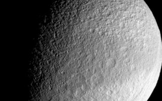 <h1>PIA09766:  Dark Belt of Tethys</h1><div class="PIA09766" lang="en" style="width:800px;text-align:left;margin:auto;background-color:#000;padding:10px;max-height:150px;overflow:auto;"><p>Around the equator on its leading side, Tethys wears a band of slightly darker surface material. Cassini imaging scientists suspect that the darkened region may represent an area of less contaminated ice with differently sized grains than the material at higher latitudes on either side of the band.</p><p>Lit terrain seen here is on the Saturn-facing side of Tethys (1071 kilometers, or 665 miles across). North is up. Part of the great canyon system Ithaca Chasma can be seen near the eastern limb in this frame-filling view.</p><p>The image was taken with the Cassini spacecraft narrow-angle camera on Sept. 30, 2007 using a spectral filter sensitive to wavelengths of infrared light centered at 930 nanometers. The view was acquired at a distance of approximately 186,000 kilometers (116,000 miles) from Tethys and at a Sun-Tethys-spacecraft, or phase, angle of 62 degrees. Image scale is 1 kilometer (0.6 mile) per pixel.</p><p>The Cassini-Huygens mission is a cooperative project of NASA, the European Space Agency and the Italian Space Agency. The Jet Propulsion Laboratory, a division of the California Institute of Technology in Pasadena, manages the mission for NASA's Science Mission Directorate, Washington, D.C. The Cassini orbiter and its two onboard cameras were designed, developed and assembled at JPL. The imaging operations center is based at the Space Science Institute in Boulder, Colo.</p><p>For more information about the Cassini-Huygens mission visit <a href="http://saturn.jpl.nasa.gov">http://saturn.jpl.nasa.gov/home/index.cfm</a>. The Cassini imaging team homepage is at <a href="http://ciclops.org">http://ciclops.org</a>.</p><br /><br /><a href="http://photojournal.jpl.nasa.gov/catalog/PIA09766" onclick="window.open(this.href); return false;" title="Voir l'image 	 PIA09766:  Dark Belt of Tethys	  sur le site de la NASA">Voir l'image 	 PIA09766:  Dark Belt of Tethys	  sur le site de la NASA.</a></div>
